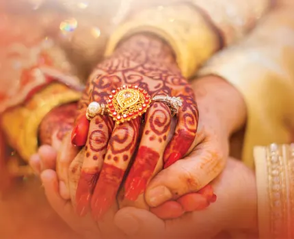 A close-up of hands held during an Indian wedding ceremony, ideal for indian wedding catering singapore.